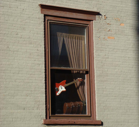 A guitar in a window in USA